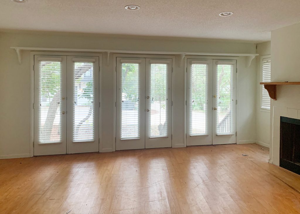 Before photo of wall of french doors in bedroom