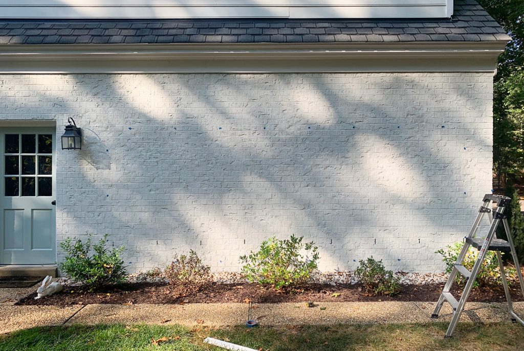 Brick Wall Marked With Blue Tape For Trellis Hooks