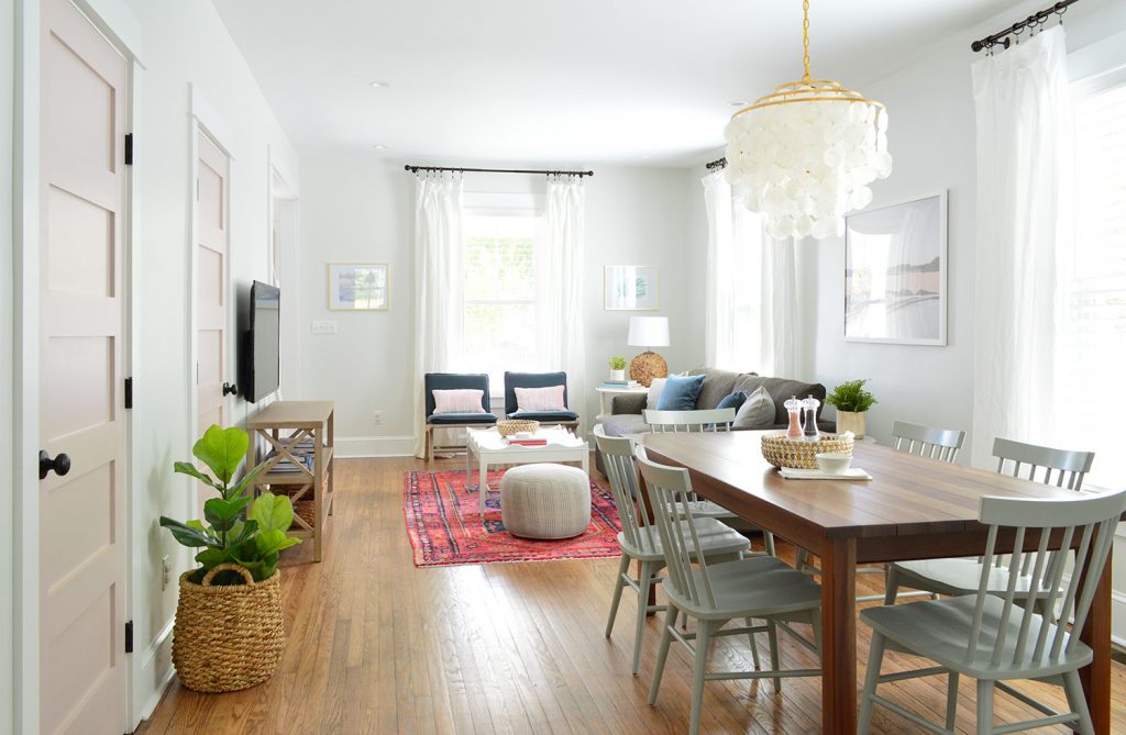 Open Living And Dining Room In Bright Beach House With Pink Doors