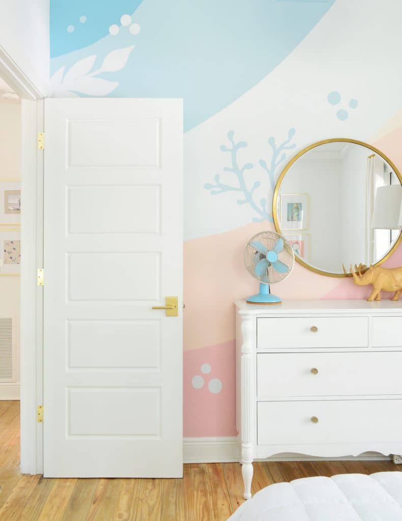 Colorful abstract painted mural in girls room with coral and seaweed