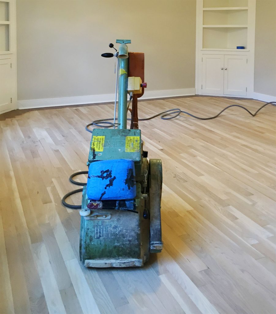 Professional floor sander on bare sanded oak floors